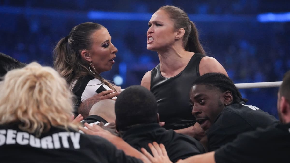 Ronda Rousey being held back by AEW officials as she shouts