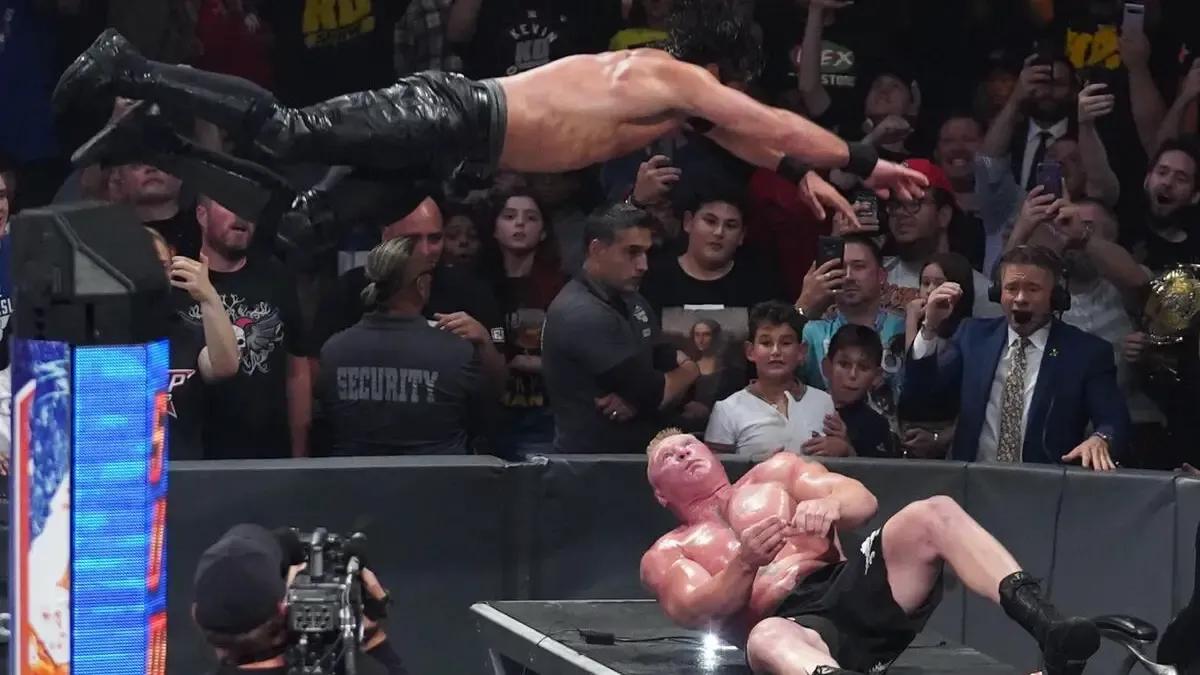 Seth Rollins Brock Lesnar announce table SummerSlam 2019.jpg