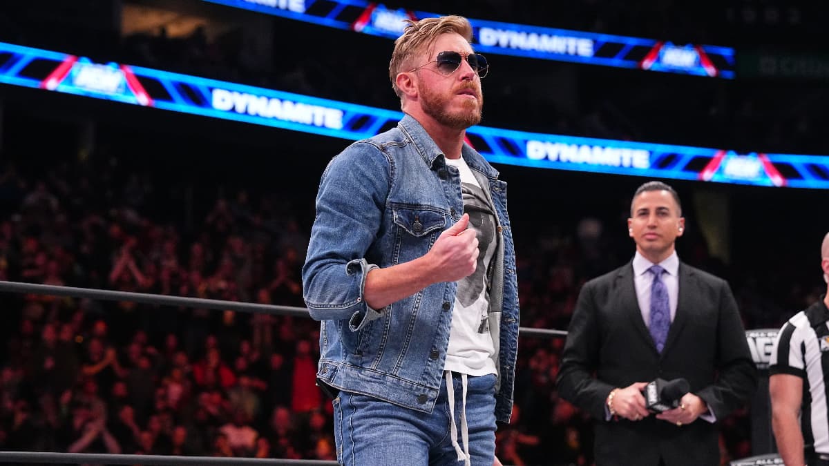 Orange Cassidy in all denim blue sticking his thumb up