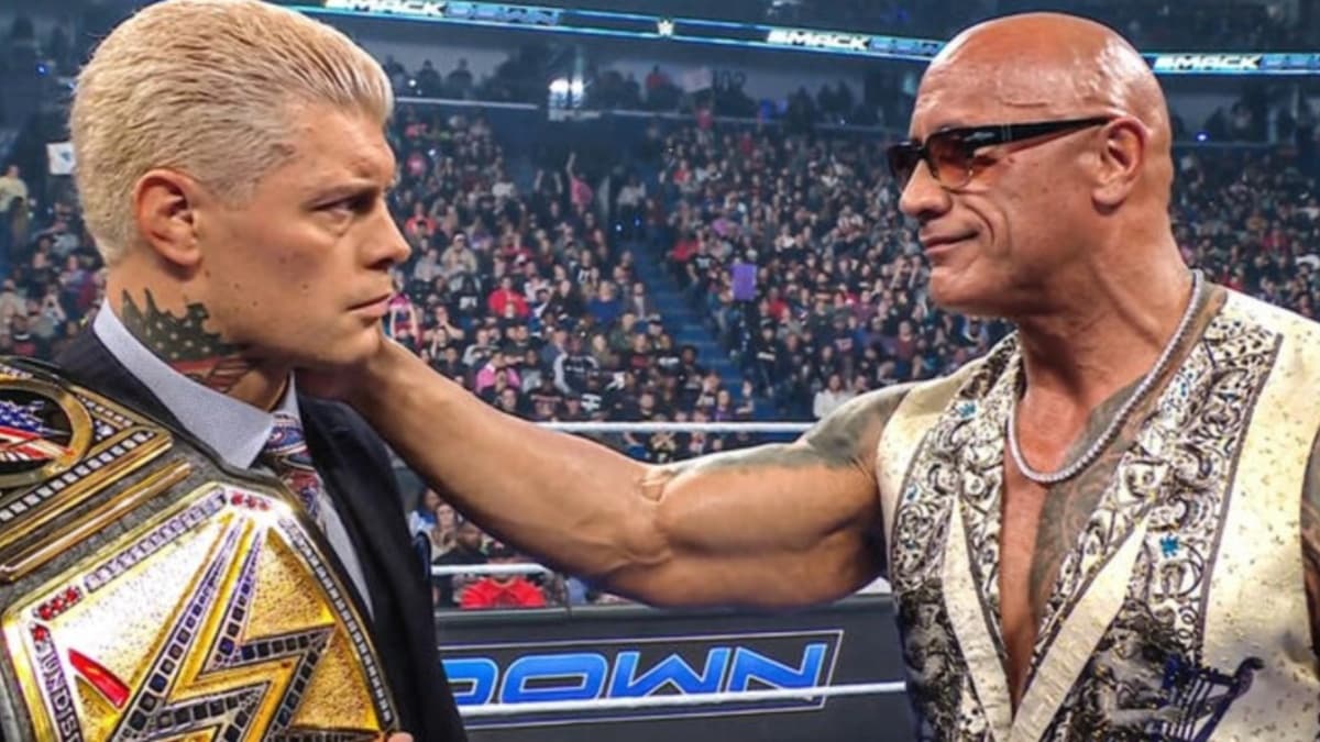 The Rock holding Cody Rhodes' shoulder